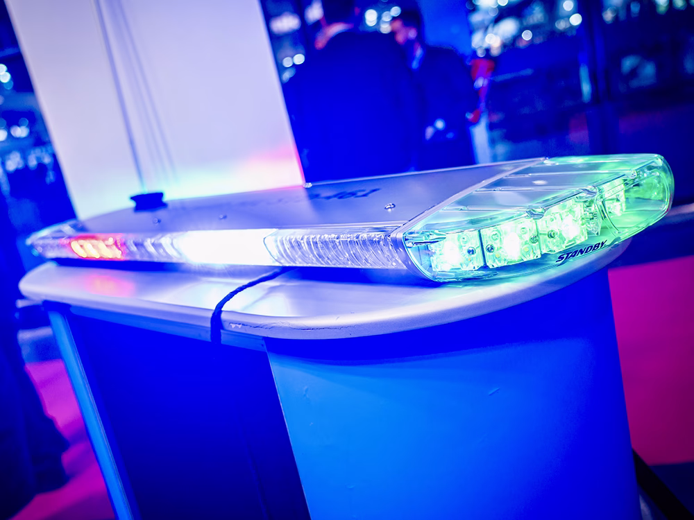 Angled view of a new Standby Lightbar (name TBA) with green, red and white lights, shown on a podium on the Standby France / Standby Group stand at Milipol Paris 2025.