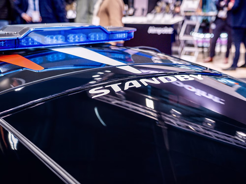 Cropped view of the blue EMY Lightbar (unlit) shown on top of a black Police Nationale McLaren on the Standby France / Standby Group stand at Milipol Paris 2025.