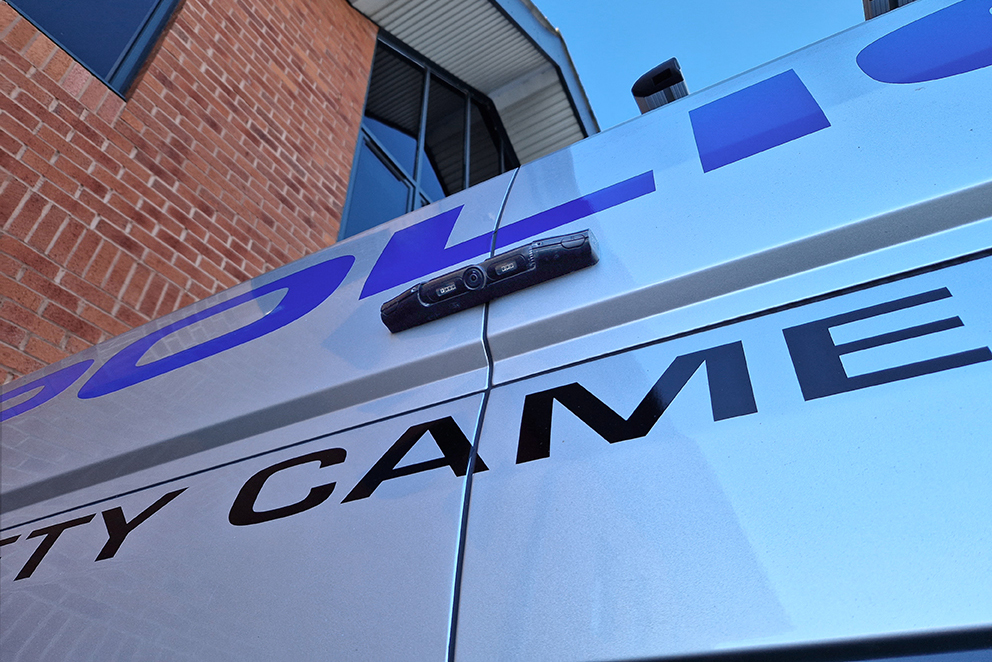 Closely Cropped Shot of the AEX License Plate Camera Mounted on the Back of A Police Safety Camera Van