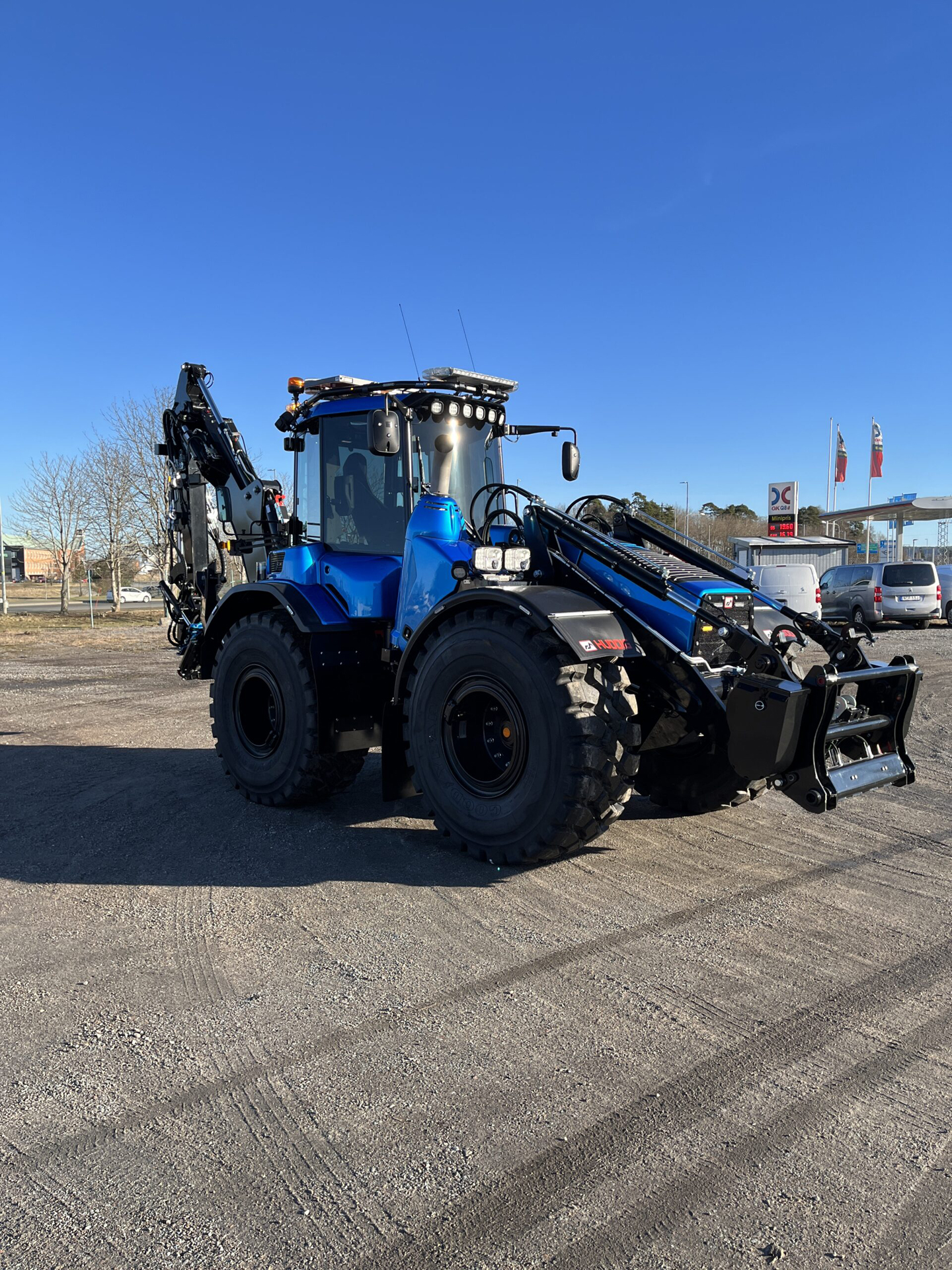 Angle View of Blue Excavator with Various Amber LED Modules and Amber W3 Lightbar with Blue Sky in Background