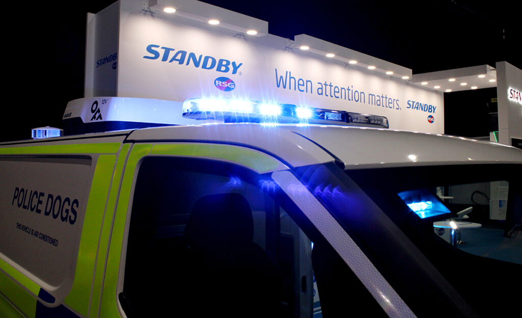 Close up of Lightbar lit blue on top of police van on Standby UK's NAPFM stand