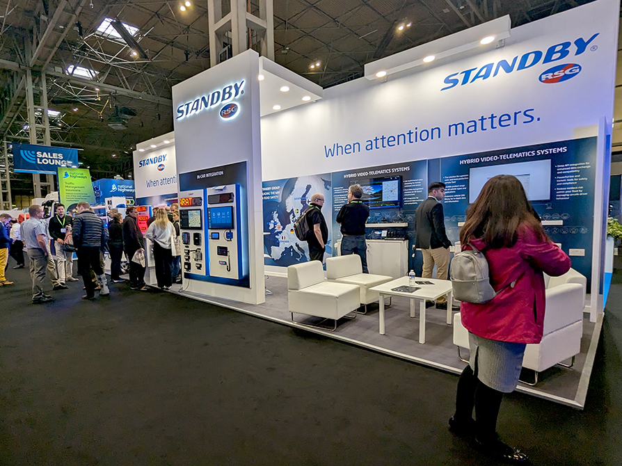 Standby RSG stand at The Emergency Services Show 2023 with groups of people crowded around.