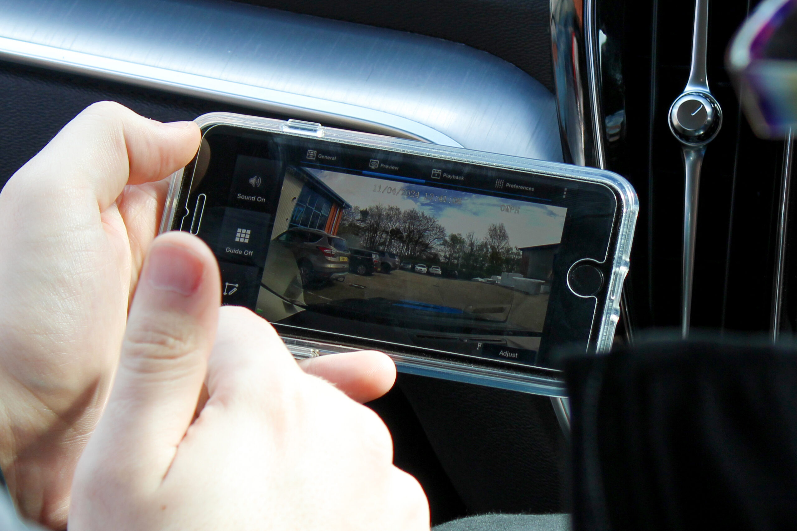 Closely cropped image of the Veyes Dash Cam App on an android phone, being held by someone in the passenger seat of a vehicle. The car dash can be seen in the background.