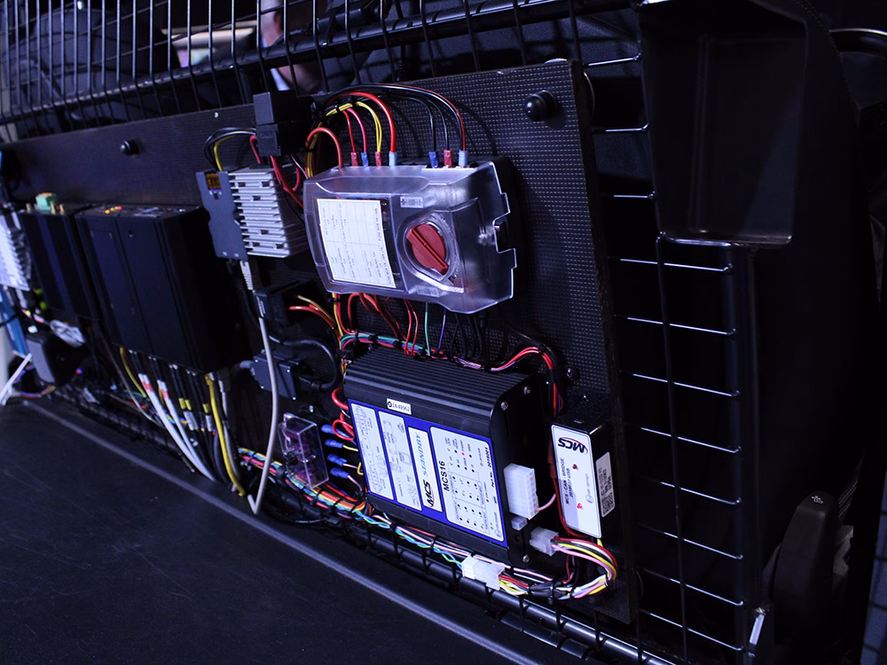 Photo of a Standby MCS-16 control unit wired on a board on a cage in the back of a vehicle, neatly wired into othe equipment.