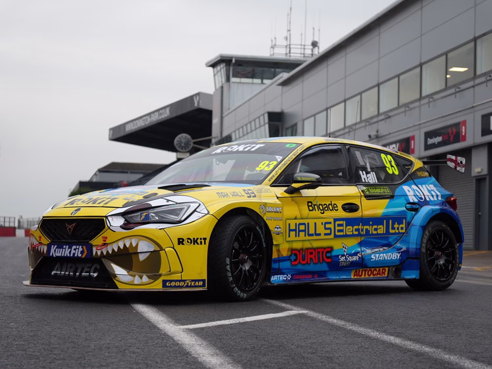 BTCC driver - Max Hall's racing car outside garage area at Donnington Park with new livery showing sponsors including Standby UK's logo