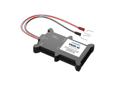 FleetMotus Vaidr 4G device angle view, lying down with red and black wires extending from the side and U shaped adaptors