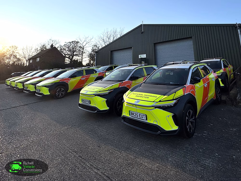 Toyota RVC BZX4s lined up at angle in front a unit. Trees and blue sky in background.