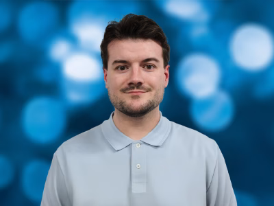 Bradley Booth, Standby UK's Business Unit Manager – Telematics, shown in front of a blue bokeh background.