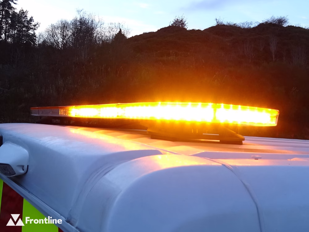 Close up of a lit Raiden LED Lightbar with Amber Cover and LEDs on a white vehicle roof taken at dusk.