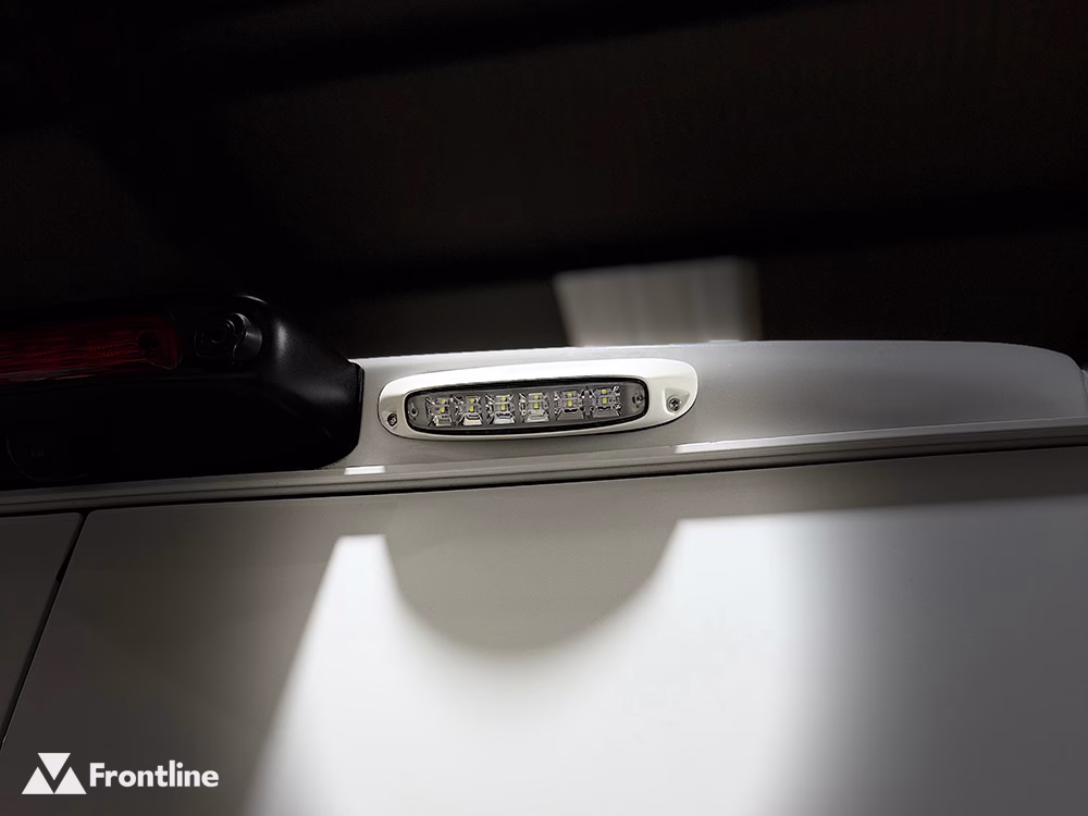 Close up of a SL209 curved Scene Light with white bezel mounted above the door of a white vehicle.